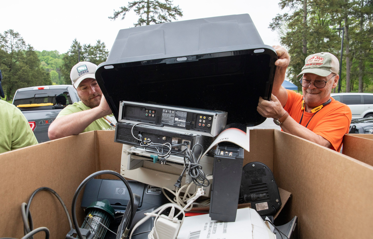 Two ORISE safety technicians assist with recycling during an annual Earth Day event