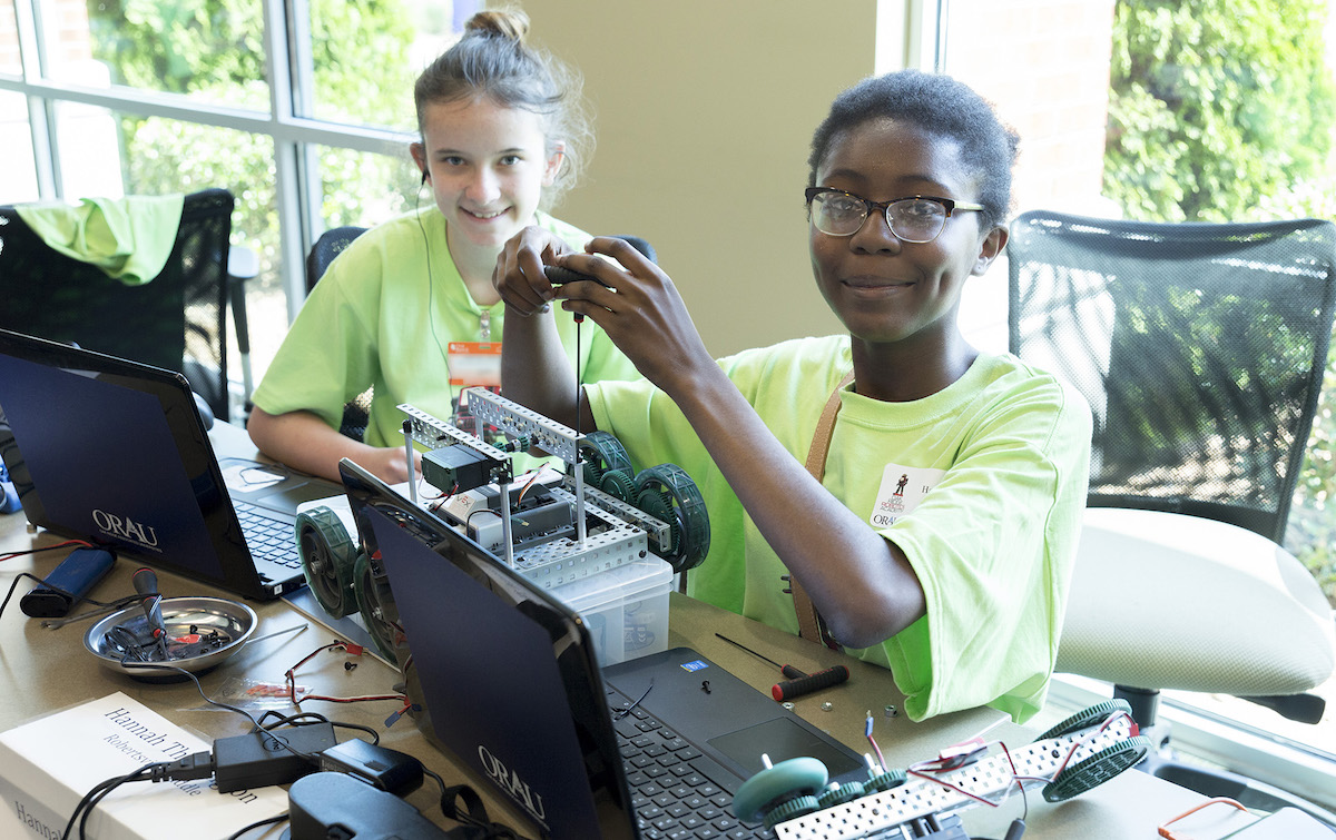 Two young females build a robot during the Oak Ridge Robotics Academy