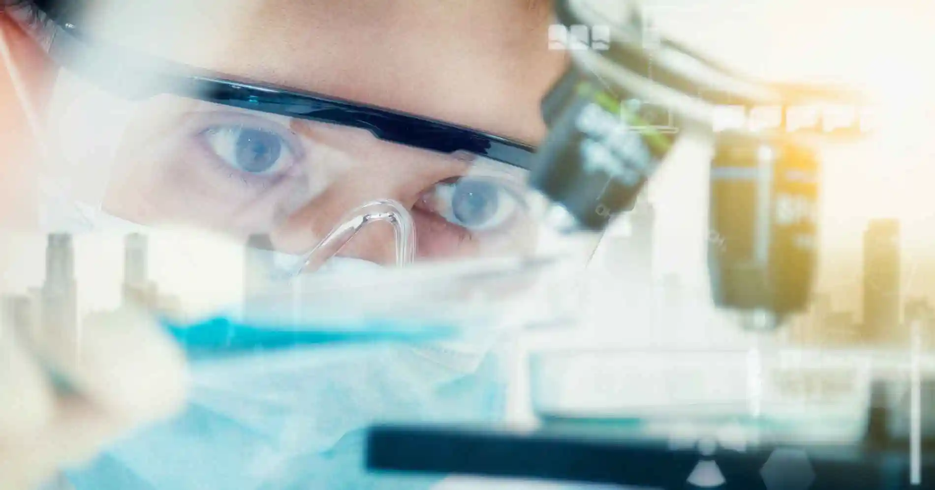 image of scientist looking intently at a microscope