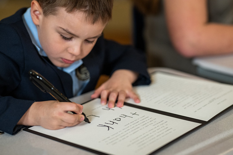 A young student participates in the Education Executive Order signing