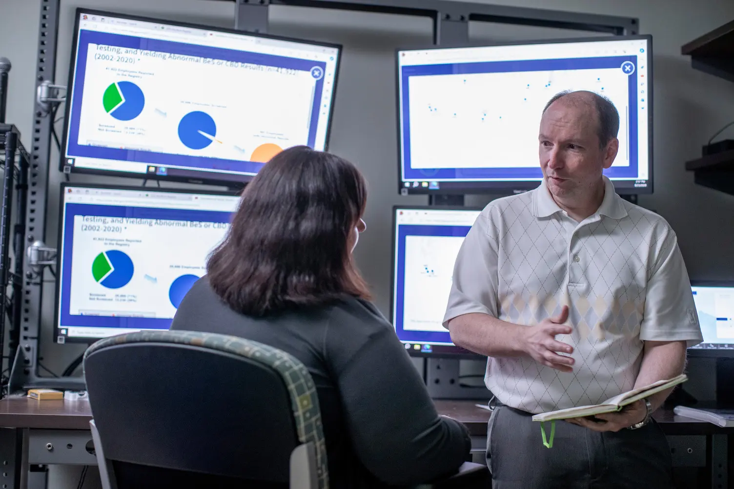 Two male IT experts work together in a server room
