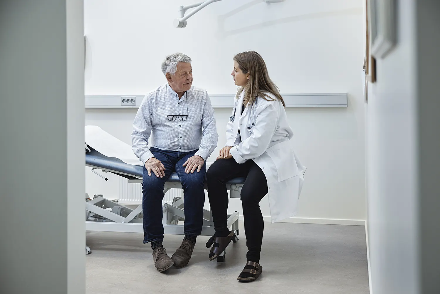 A physician talks to a patient in a medical office