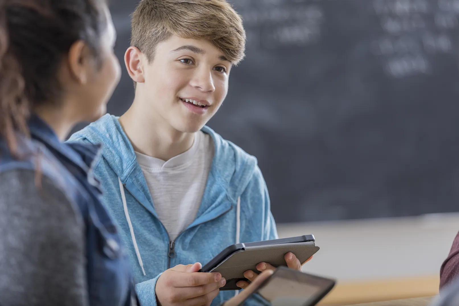 A high school student participates in after school study group using a digital tablet.