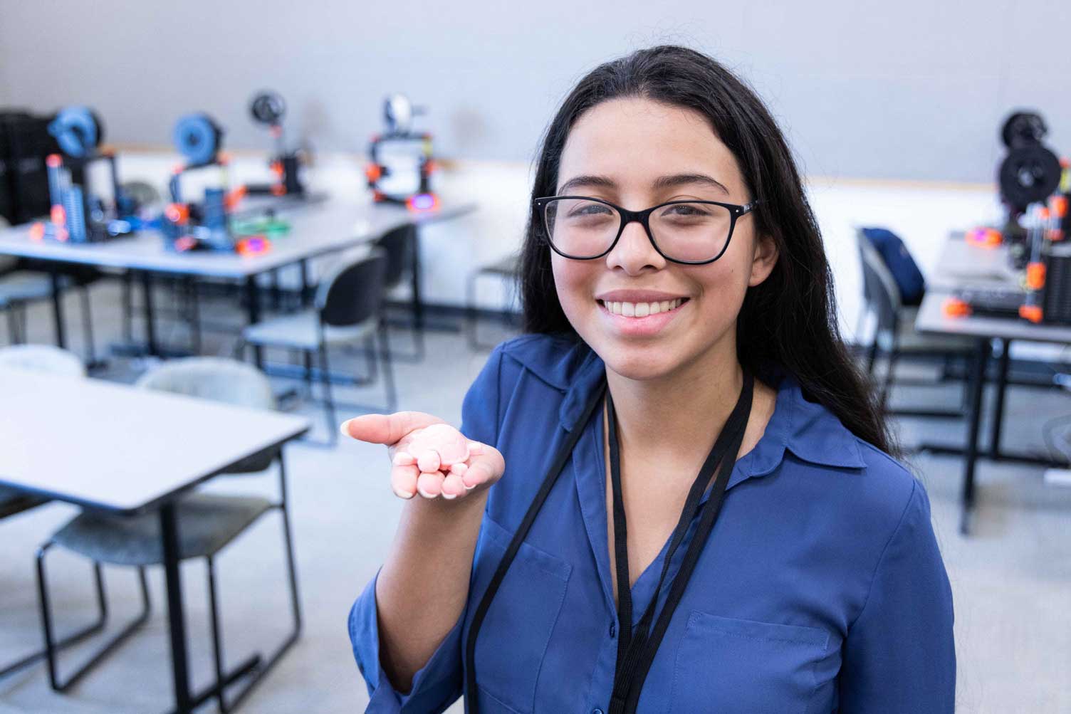 A student holds a 3D printed object during the Joint Science and Technology Institute, Aberdeen Proving Ground