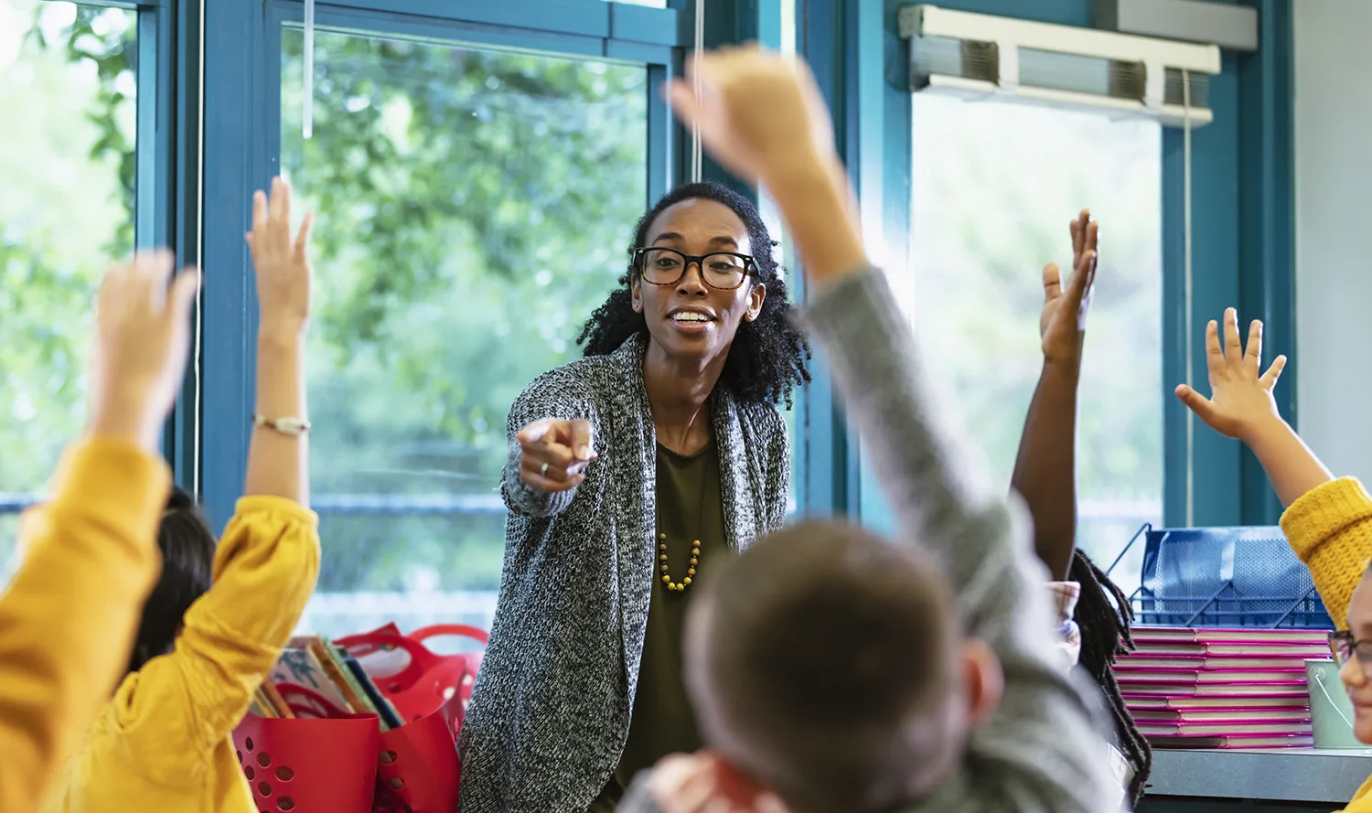 A female teacher in the classroom with her students