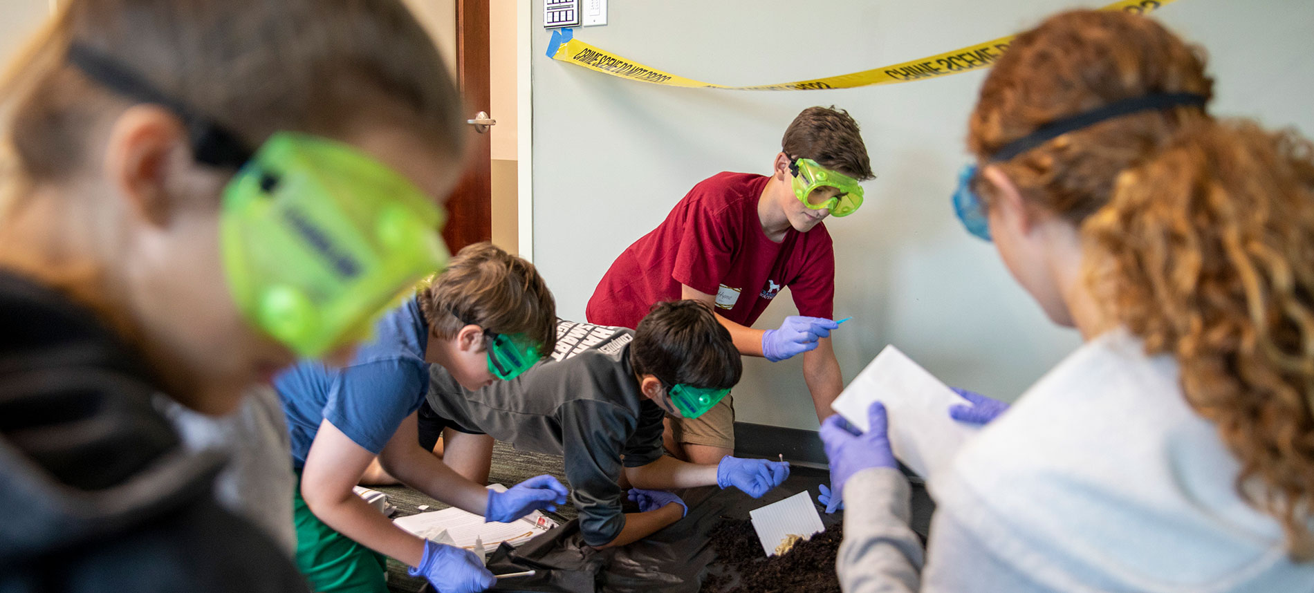 A group of high school students examines evidence during the ORAU Forensic Chemistry Mini-Academy