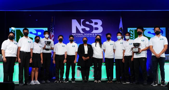 Director of the Office of Science Dr. Asmeret Berhe (pictured middle wearing black blazer) stands with the winning teams of the 2022 DOE National Science Bowl Championship—Odle Middle School from Bellevue, Wash. (on the left), and Lynbrook High School from San Jose, Calif. (on the right). Photo credit: Jack Dempsey, National Science Bowl, Department of Energy, Office of Science.