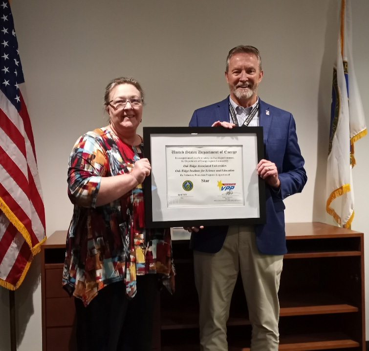 ORNL Site Office Deputy Manager Michele Branton (left) presented ORISE Director Jim Vosburg (right) with an official certificate acknowledging ORISE’s continued status as a DOE Voluntary Protection Program (VPP) Star Site. 