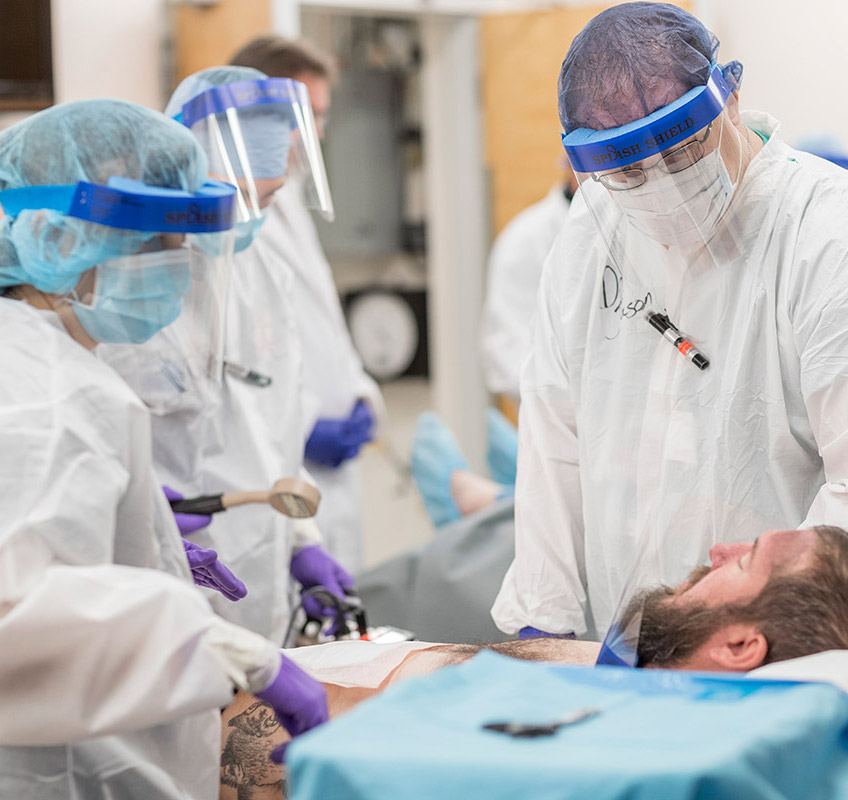 Emergency medical staff assess and treat contaminated patient