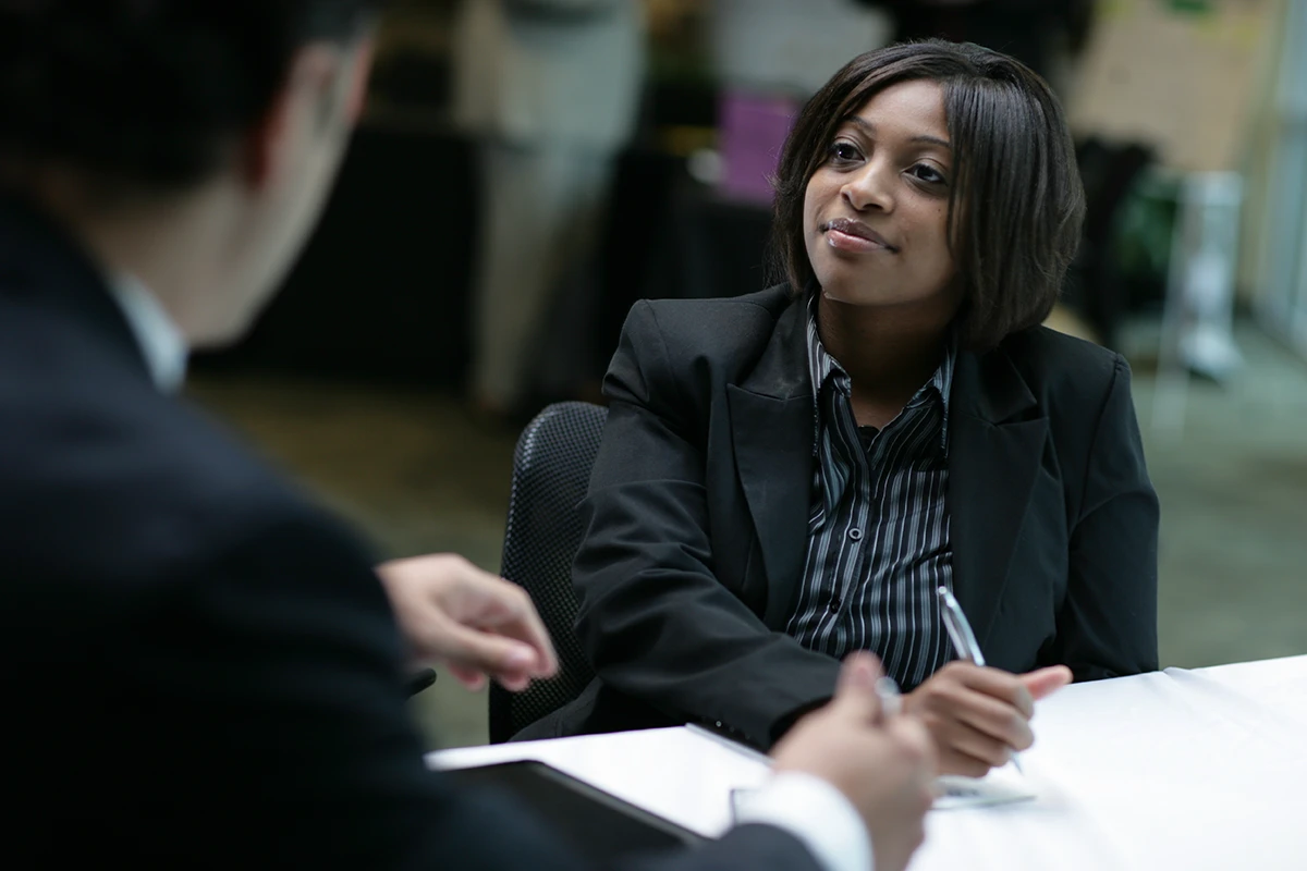 Young woman talks to male interviewer during interview