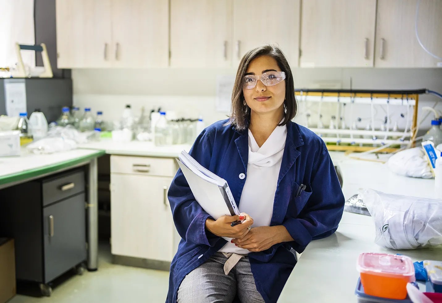 A young female conducts research in a laboratory setting