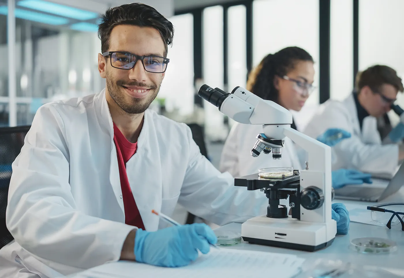 Researcher analyzes samples and uses microscope