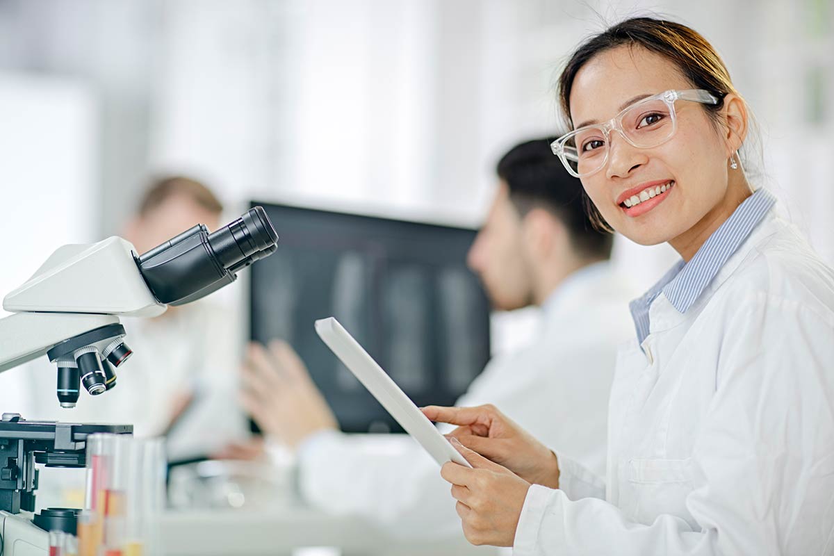 A female postdoctoral researcher in a laboratory setting